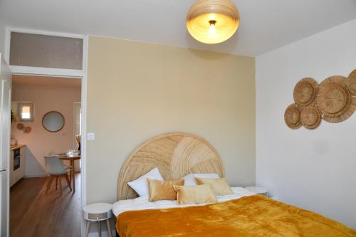 a bedroom with a large bed with a wooden headboard at Domaine des Étoiles - Gîtes in Gillonnay
