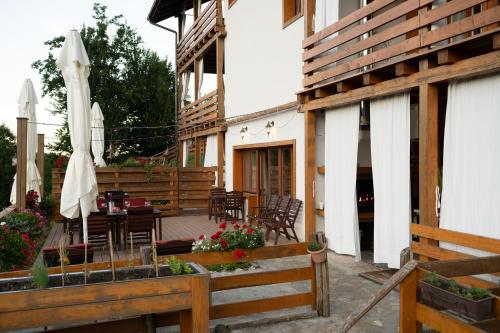 a patio with a table and chairs and an umbrella at B&B Apartments Burić Plitvice Lakes in Plitvička Jezera