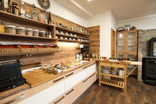 a large kitchen with wooden shelves and a counter at B&B Apartments Burić Plitvice Lakes in Plitvička Jezera