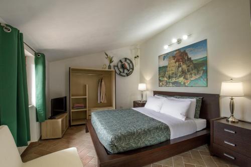 a bedroom with a large bed and a tv at Centro e Spiaggia malachite in Anguillara Sabazia