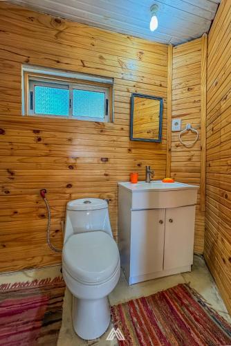 a bathroom with a toilet and a sink at SAGRADAS de LA PALOMA in La Paloma