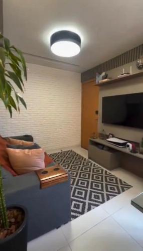 a living room with a couch and a flat screen tv at Samambaia QR in Samambaia