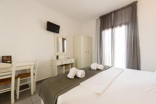 a bedroom with a bed with two pillows on it at Archipelagos Studios in Naousa