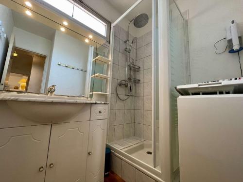 une salle de bain avec un lavabo et une douche avec un miroir dans l'établissement Appartement 2 pièces cabine 6 couchages ST CYPRIEN PLAGE SC220-007, à Saint Cyprien Plage