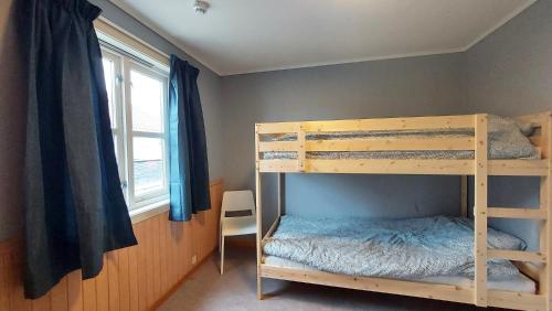 a bedroom with two bunk beds and a window at Leilighet rett ved stranden in Mandal