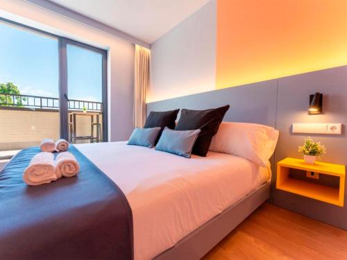 a bedroom with a large bed with towels on it at La marina sunset 3000 in Soto de la Marina