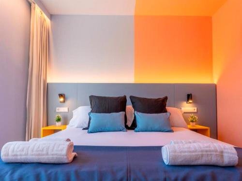 a bedroom with a large bed with two pillows on it at La marina sunset 3000 in Soto de la Marina