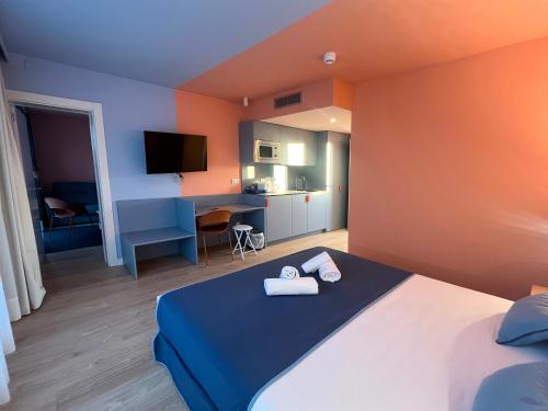 a bedroom with a bed with two towels on it at La marina sunset 3000 in Soto de la Marina