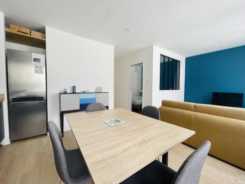 - une cuisine et une salle à manger avec une table et un canapé dans l'établissement La Petite Fonderie 2eme etage - Bel Appt Centre Ville Lr Wifi, à La Rochelle