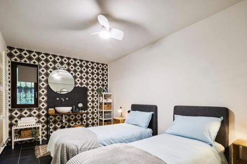 a bedroom with two beds and a mirror at The Peaceful Apartament Close to Milan in Trezzano sul Naviglio