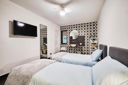a bedroom with two beds and a mirror at The Peaceful Apartament Close to Milan in Trezzano sul Naviglio