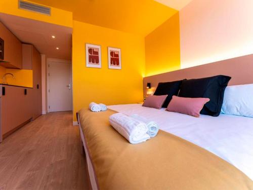 a bedroom with a large bed with yellow walls at La marina sunset 3000 in Soto de la Marina