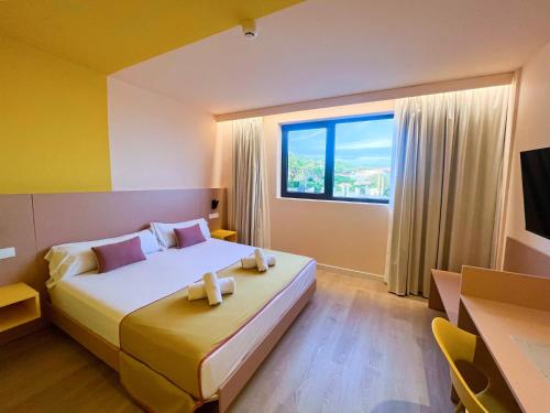 a bedroom with a large bed and a window at La marina sunset 3000 in Soto de la Marina