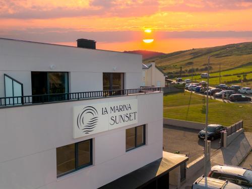 a view of a building with the sunset in the background at La marina sunset 3000 in Soto de la Marina