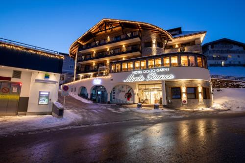 a building on a street in the snow at night at Hotel Garni Monte Bianco in Ischgl