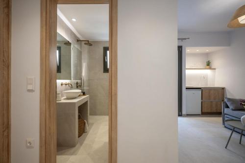 a bathroom with a sink and a toilet in a room at Aplomata Naxos Apartments in Naxos Chora