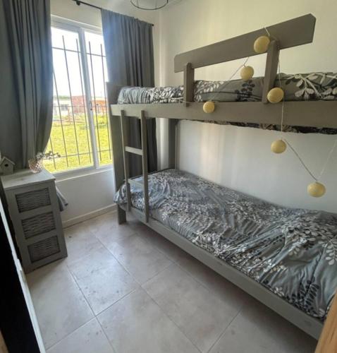 a bedroom with two bunk beds and a window at El Alivio in Zárate