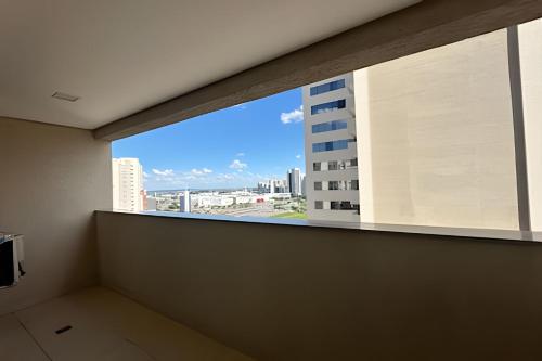 a room with a window with a view of a building at iFlat Brookfield Towers BT2103 Jardim Goiás in Goiânia