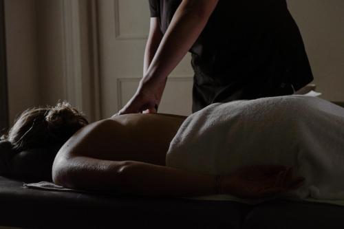 a woman laying on a couch getting a massage at Casa Bouchon Hotel Boutique in San Javier