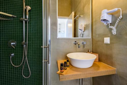 a bathroom with a sink and a shower at Archipelagos Studios in Naousa