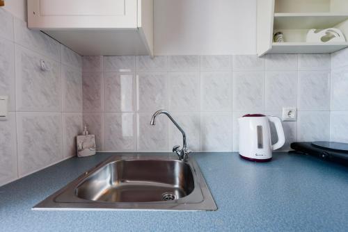 a kitchen counter with a sink and a toaster at Archipelagos Studios in Naousa