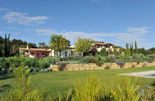 a house with a garden and a yard with a yard at New Stylish Villa with Swimming Pool in Capalbio in Pescia Fiorentina