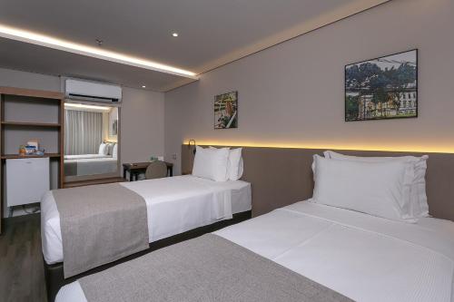 Una cama o camas en una habitación de Hotel Roochelle Convention By Nobile