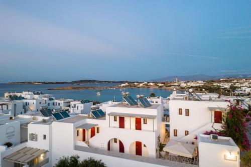 a view of a town with white buildings and the water at Archipelagos Studios in Naousa