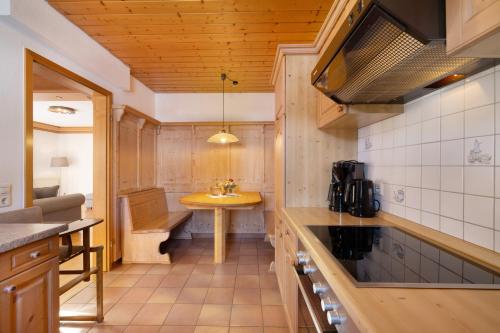 a small kitchen with a sink and a table at Pension Vogtsmichelhof - Haupthaus in Alpirsbach