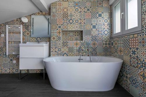 une salle de bain avec une baignoire blanche et un lavabo dans l'établissement Superbe Duplex avec Terrasse au Cœur de Metz, à Metz