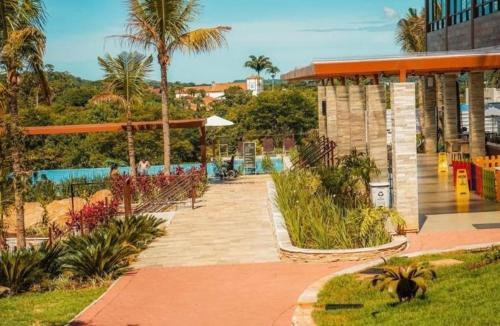 a resort with a swimming pool and palm trees at Eco Resort QUINTA SANTA BÁRBARA in Pirenópolis