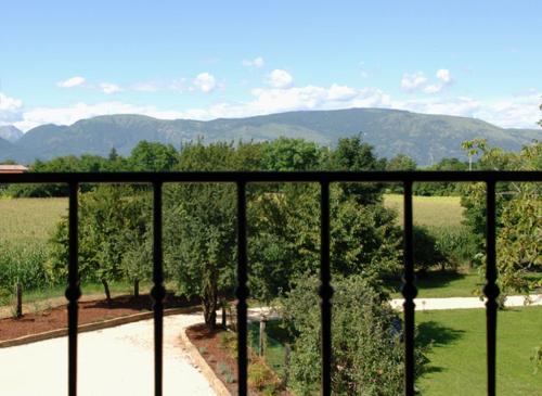 a balcony with a view of a field and trees at Albergo Julienne in Arba