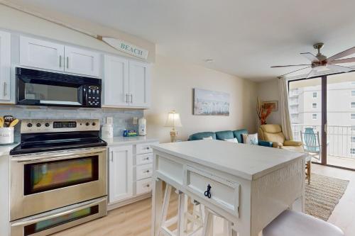 a kitchen with white cabinets and a stove top oven at Seaside Beach & Racquet Club #4611 in Orange Beach