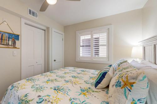 a bedroom with a bed and a window at Seaside Beach & Racquet Club #4611 in Orange Beach
