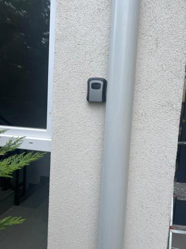 a sensor on a wall next to a window at Kleon Apartament in Pristina