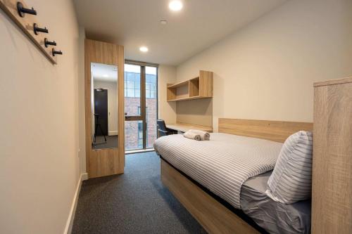 a small bedroom with a bed and a television at Practical Room For One, Central Nottingham in Nottingham