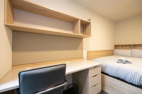 a small bedroom with a desk and a bed at Practical Room For One, Central Nottingham in Nottingham