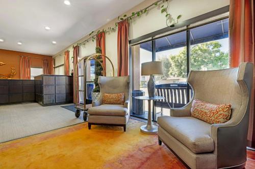 a living room with two chairs and a table at Best Western Royal Palace Inn & Suites in Los Angeles
