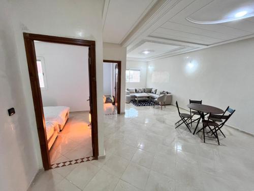 Una sala de estar con una cama, una mesa y sillas. en Charming Two Bedroom Apartment in Fes Near City Center, en Fez