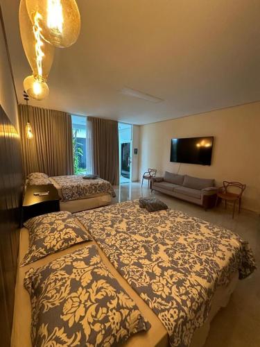 a hotel room with a bed and a couch at Villa'S Roraima in Boa Vista