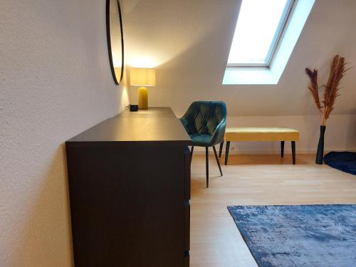 a living room with a desk with a lamp and a chair at maremar - Design-Maisonette am Holzmarkt - Luxus Boxspringbetten - Arbeitsplatz - Loggia in Verden