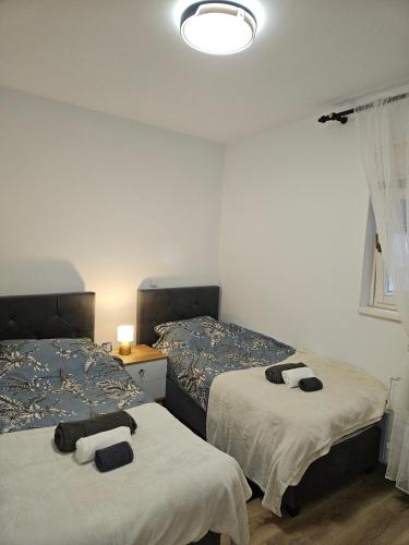 a bedroom with two beds with towels on them at Apartman Judita in Zagreb