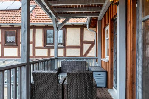 a patio with chairs and a table on a porch at Ferienwohnung 1 Hof Schäfer in Waldeck
