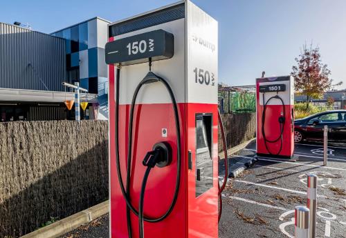 two gas pumps are parked in a parking lot at B&B HOTEL Bordeaux Langon in Langon