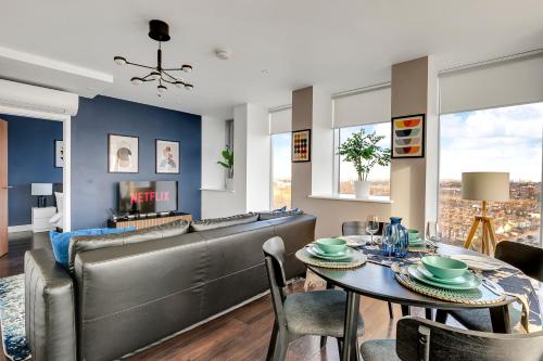 a living room with a couch and a table at Last-Minute Escape l Sleeps Up to 6 l Stylish City Views Near Station by Capital Retreat Short lets & Serviced Accommodations in Merton