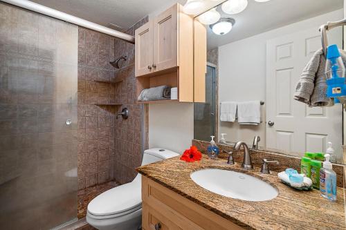 a bathroom with a sink and a toilet at Sea Village 4-205 in Kailua-Kona