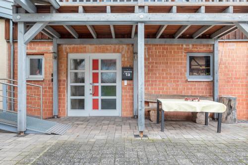 a brick building with a table in front of a door at Ferienwohnung 2 Hof Schäfer in Waldeck