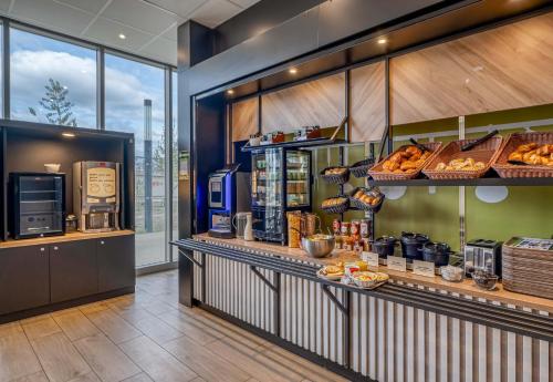 a bakery with a counter with bread and pastries at B&B HOTEL Bordeaux Centre Gare Saint-Jean in Bordeaux