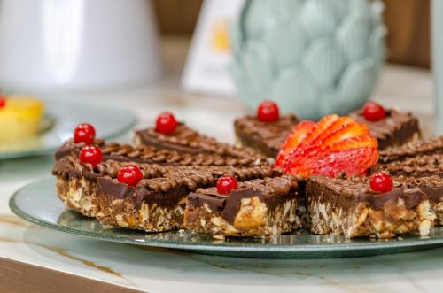 a plate of chocolate desserts with a strawberry on top at TURIM Lisboa Hotel in Lisbon
