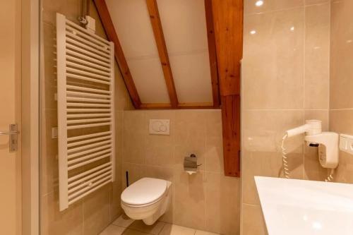 a bathroom with a toilet and a sink at Boutique Hotel Maldegem in Vlissingen